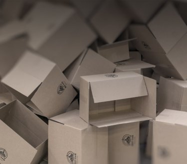 piled cardboard boxes, symbolizing one out of more materials
